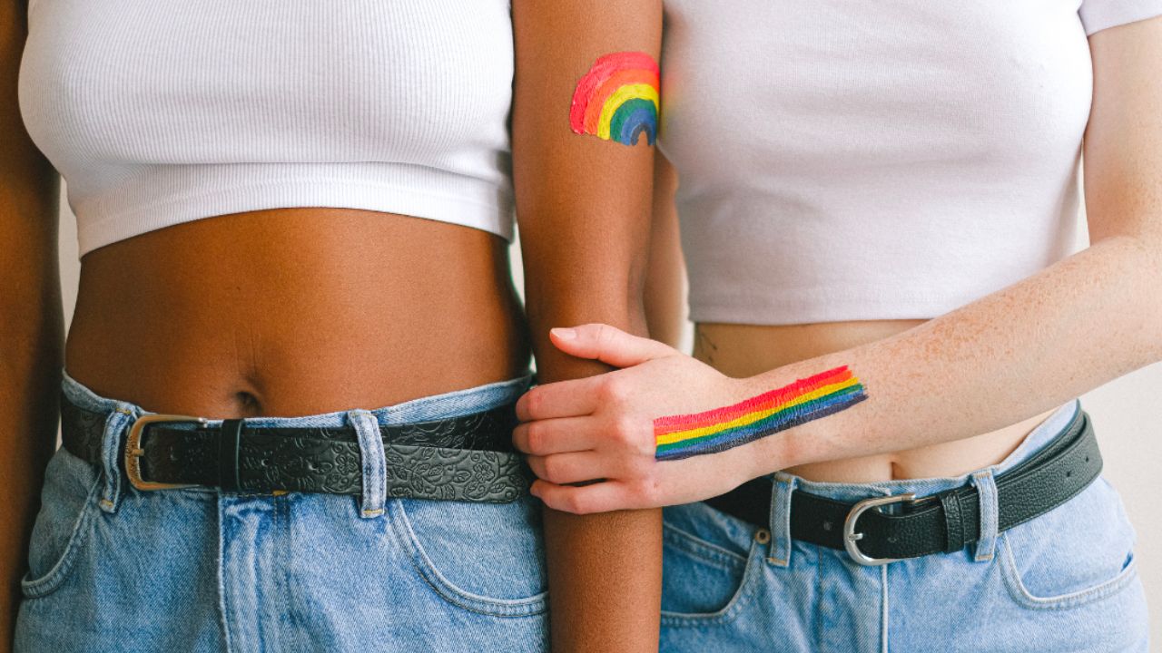 diverse people with pride rainbow painted on their skin